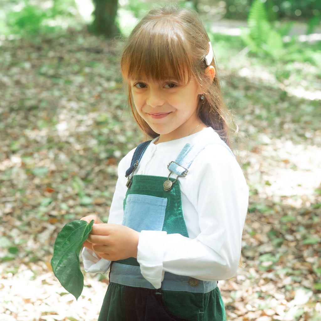 girl wearing dungaree dress blackthorn patchwork